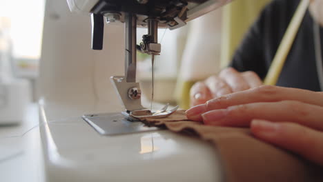 Hands-of-Seamstress-Using-Sewing-Machine